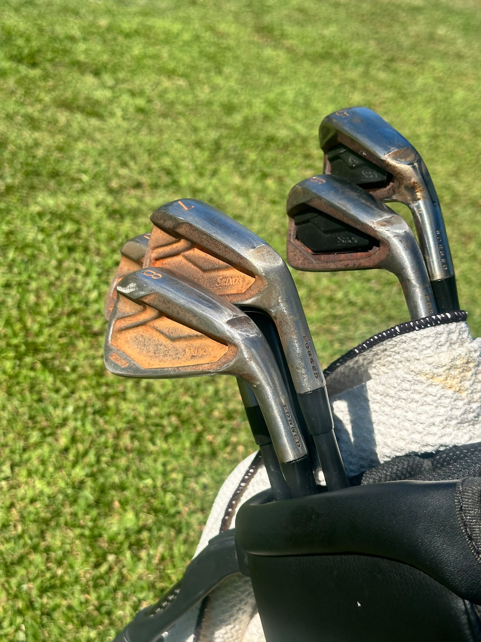 Patina-finished Srixon iron heads from an Oceans Golf restoration